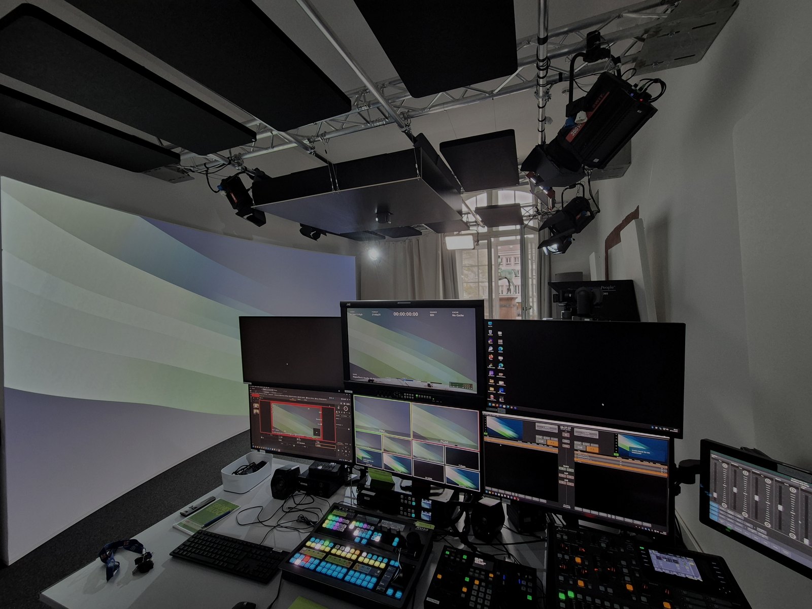 Hybrid event production room with control screens and monitoring systems